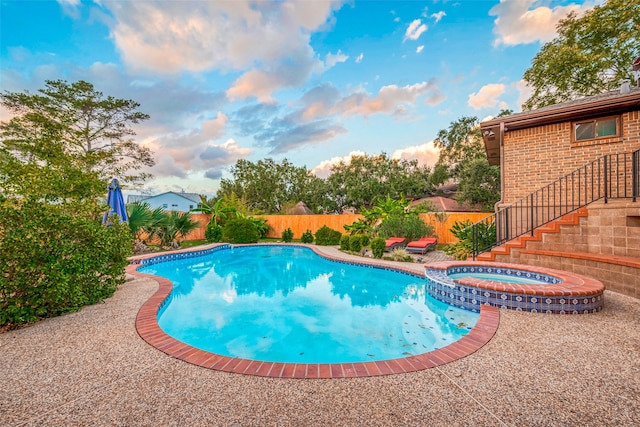 view of swimming pool featuring an in ground hot tub