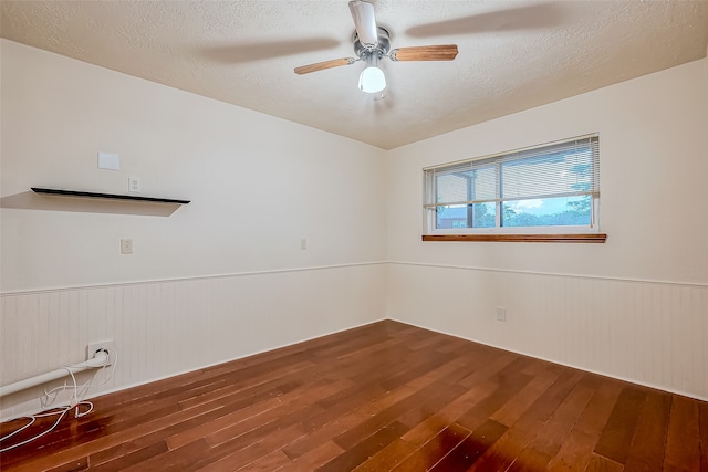 empty room featuring a textured ceiling, wood-type flooring, and ceiling fan