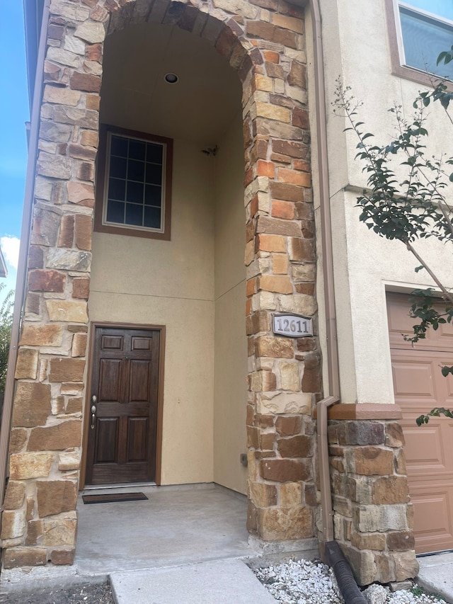 doorway to property featuring a garage