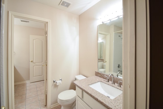 bathroom with vanity, toilet, walk in shower, and tile patterned flooring