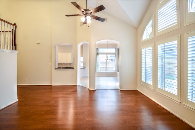 unfurnished living room featuring dark hardwood / wood-style floors, high vaulted ceiling, and a wealth of natural light