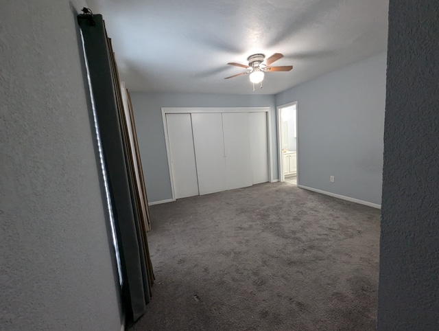 unfurnished bedroom featuring carpet flooring, ceiling fan, and a closet