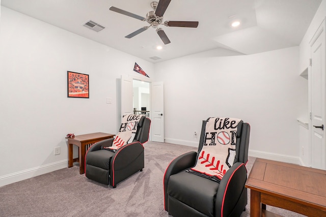 living area featuring ceiling fan and light carpet