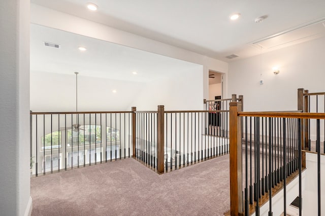 hall with lofted ceiling and carpet