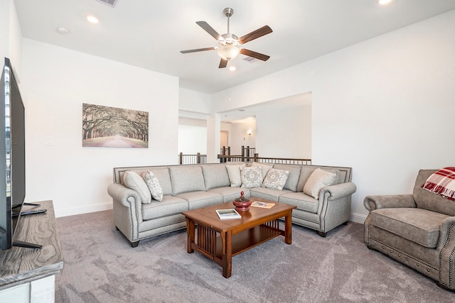 carpeted living room with ceiling fan