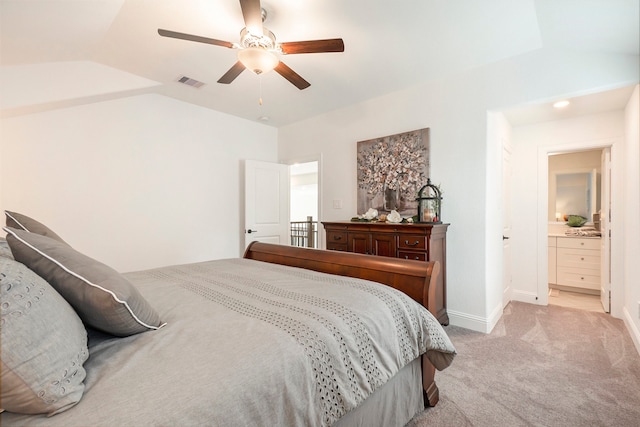 carpeted bedroom with connected bathroom, ceiling fan, and vaulted ceiling