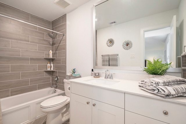 full bathroom with vanity, toilet, and tiled shower / bath