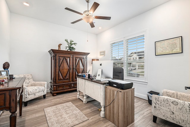 office featuring light hardwood / wood-style floors and ceiling fan