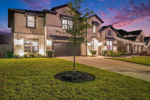 view of front facade featuring a garage and a lawn