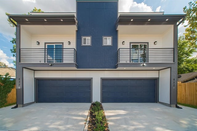 contemporary home featuring a balcony and a garage