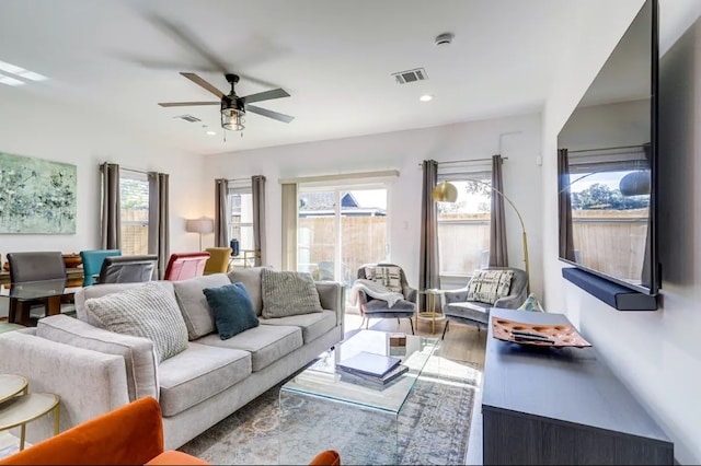 living room with hardwood / wood-style flooring, plenty of natural light, and ceiling fan