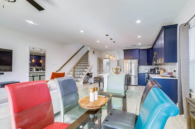 dining room with light hardwood / wood-style flooring and ceiling fan