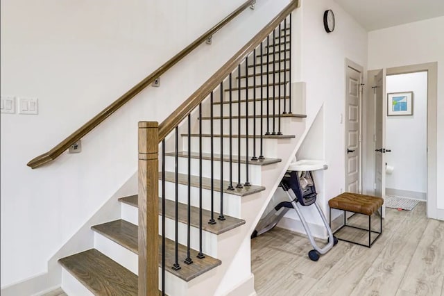 stairway featuring wood-type flooring