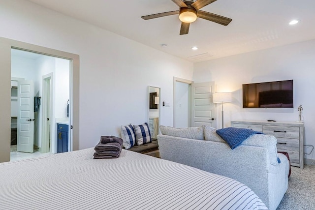 bedroom with ensuite bathroom, carpet flooring, and ceiling fan