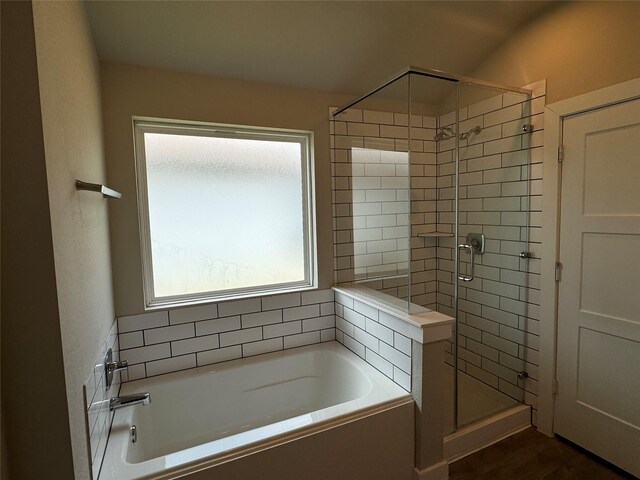 12287 Council Grove Dr, Conroe, TX 77384 - bathroom with a shower stall, wood finished floors, and a bath