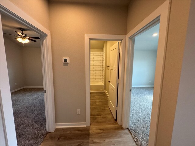 12287 Council Grove Dr, Conroe, TX 77384 - corridor with baseboards, carpet flooring, and wood finished floors