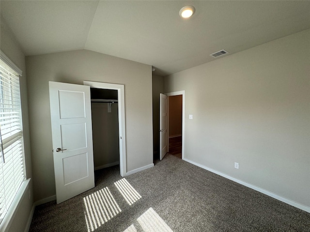 unfurnished bedroom featuring carpet floors, multiple windows, baseboards, and visible vents