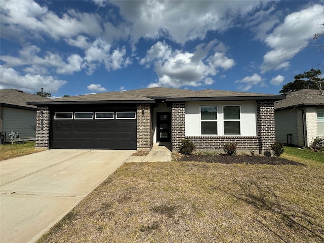 view of front of property with a garage and a front lawn