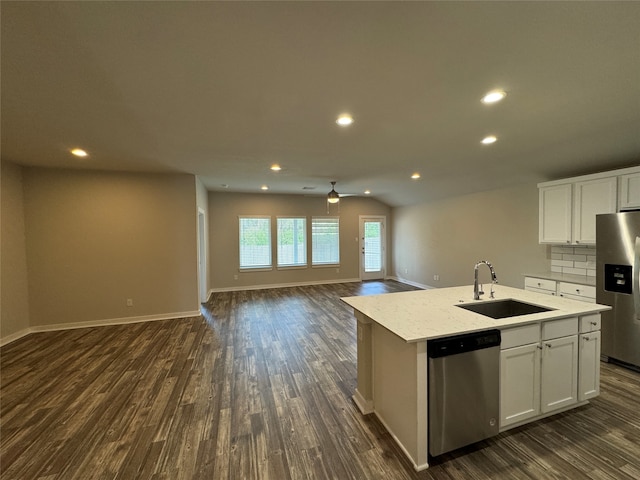 kitchen with sink, a kitchen island with sink, stainless steel appliances, and white cabinetry