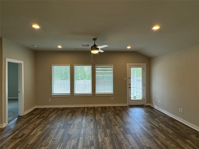 empty room with dark wood-type flooring, ceiling fan, and vaulted ceiling