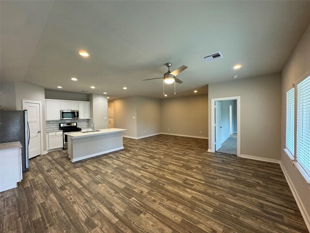 12287 Council Grove Dr, Conroe, TX 77384 - kitchen with open floor plan, ceiling fan, dark wood-style floors, a sink, and stainless steel appliances