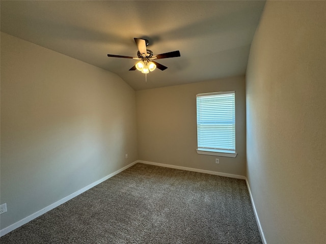 carpeted empty room featuring vaulted ceiling and ceiling fan