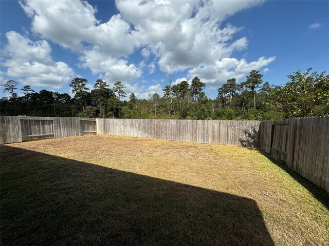 12287 Council Grove Dr, Conroe, TX 77384 - view of yard with a fenced backyard