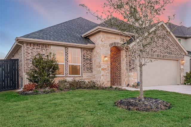 ranch-style house with a yard and a garage