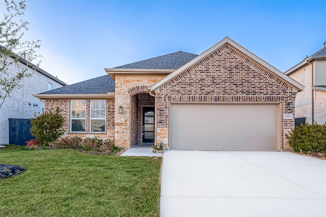 view of front facade with a front yard and a garage