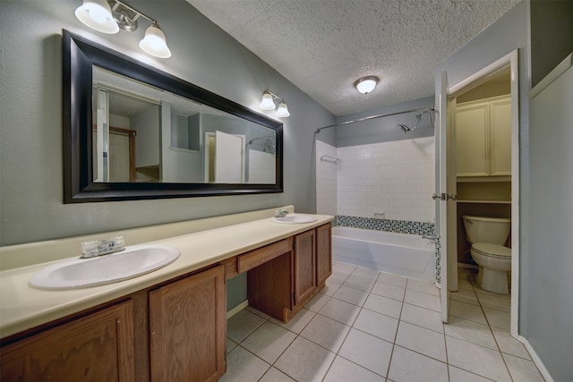 full bathroom with vanity, tiled shower / bath combo, toilet, and tile patterned flooring