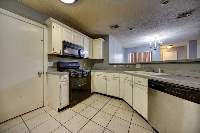 kitchen featuring light tile patterned flooring, a textured ceiling, a chandelier, and black appliances