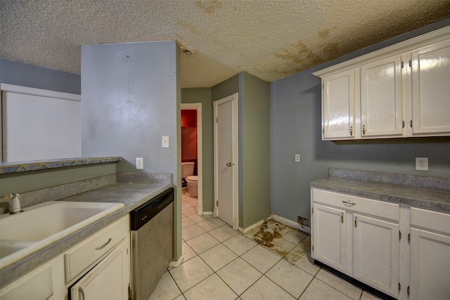 kitchen featuring dishwasher, white cabinets, and a textured ceiling