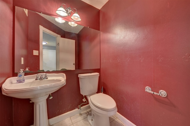 bathroom with toilet and tile patterned flooring