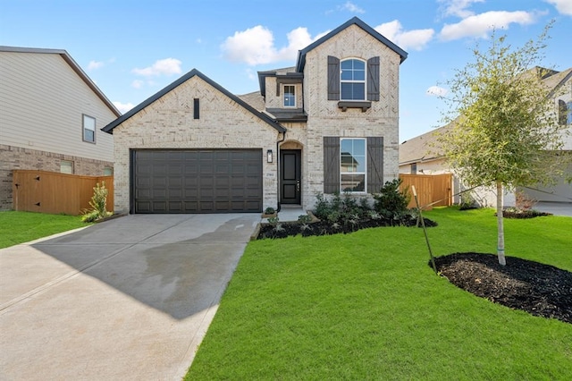 view of front of property with a garage and a front lawn