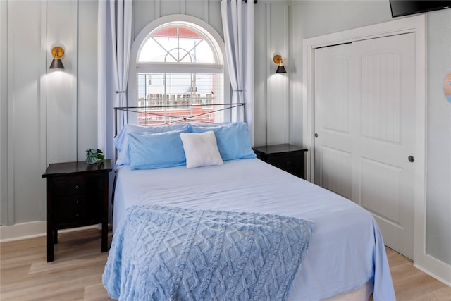 bedroom with light hardwood / wood-style flooring and a closet