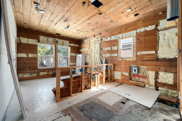 miscellaneous room with wooden ceiling, wood-type flooring, and wooden walls