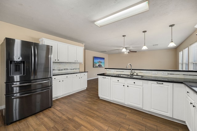 kitchen with dark hardwood / wood-style floors, white cabinets, sink, and stainless steel fridge with ice dispenser