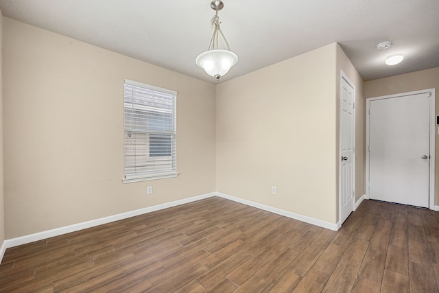 spare room with dark wood-type flooring