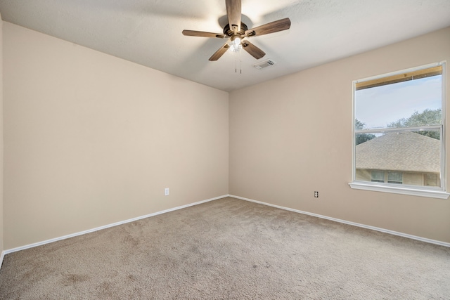 carpeted spare room featuring ceiling fan