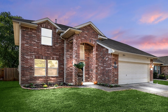 front of property with a garage and a lawn