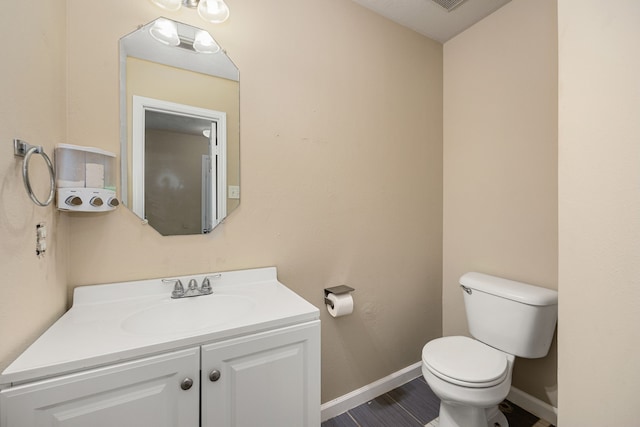 bathroom with toilet and vanity