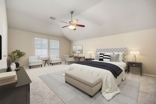 carpeted bedroom with ceiling fan and vaulted ceiling