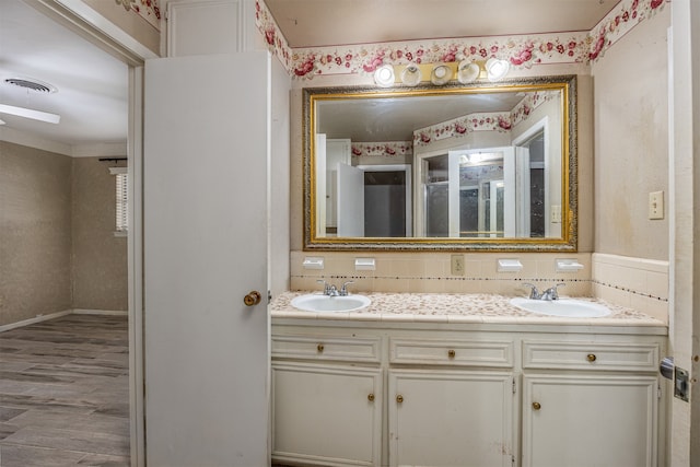 bathroom featuring vanity, decorative backsplash, and wood-type flooring