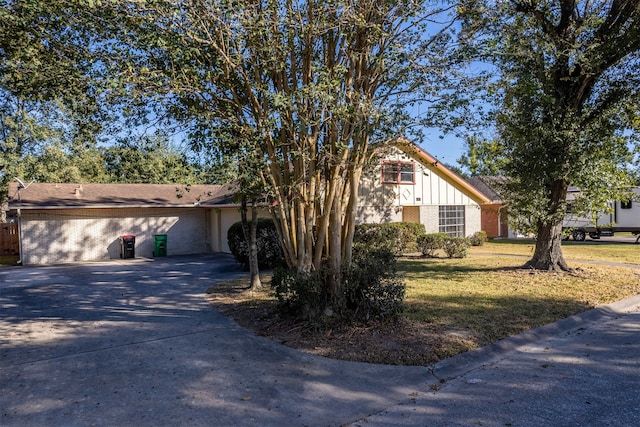 view of front of property with a front yard and a garage