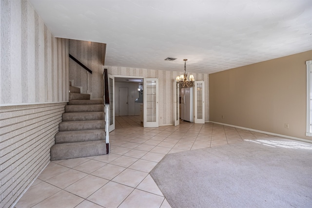 interior space featuring light tile patterned flooring and a chandelier