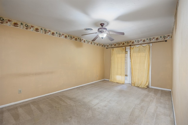 carpeted empty room featuring ceiling fan