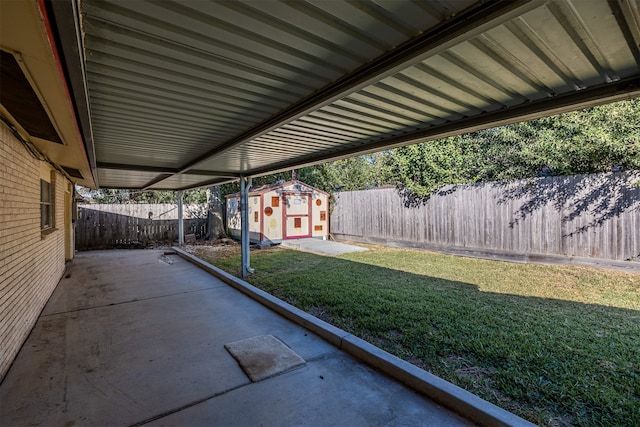 view of yard featuring a storage unit and a patio