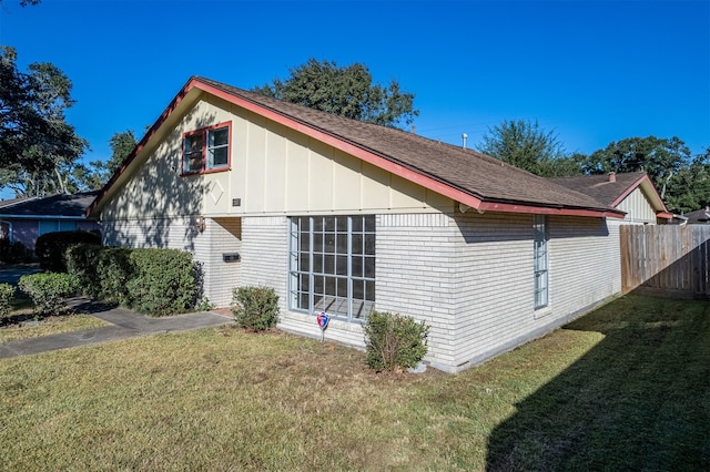 view of side of property with a yard