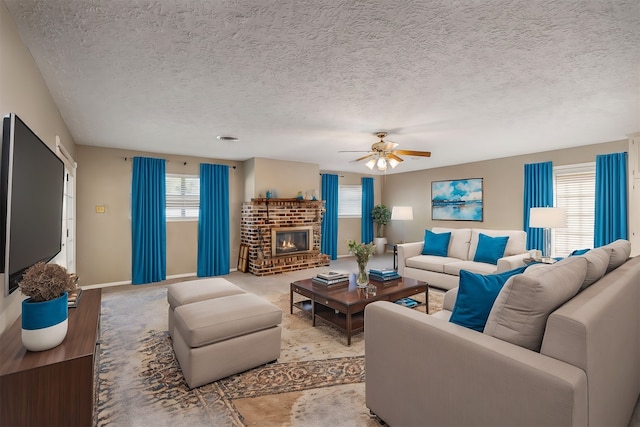 carpeted living room featuring a fireplace, a textured ceiling, and ceiling fan