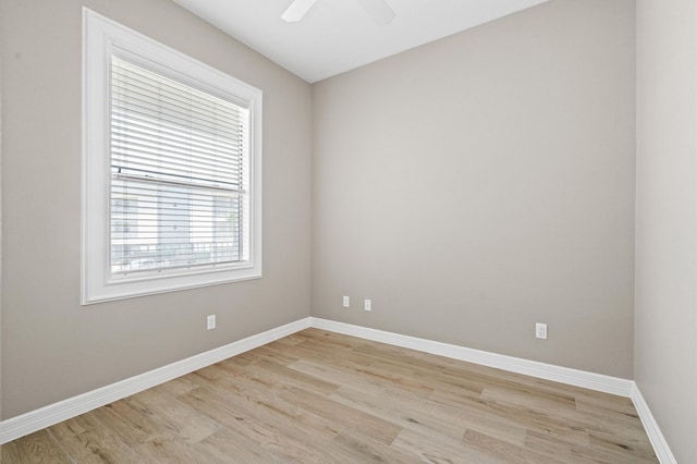 spare room featuring light wood-type flooring and ceiling fan